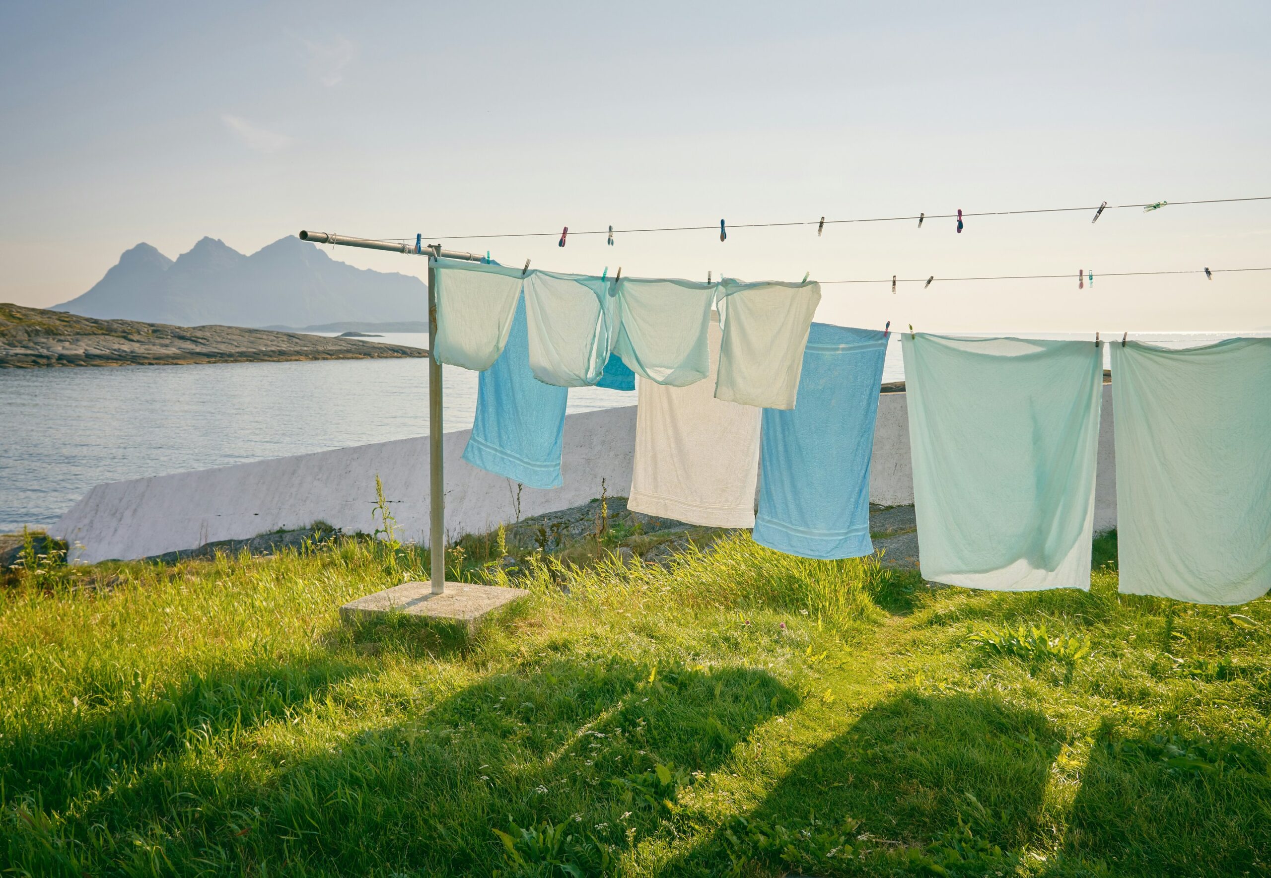 Clothes hanging on a clothes line on a grassy path